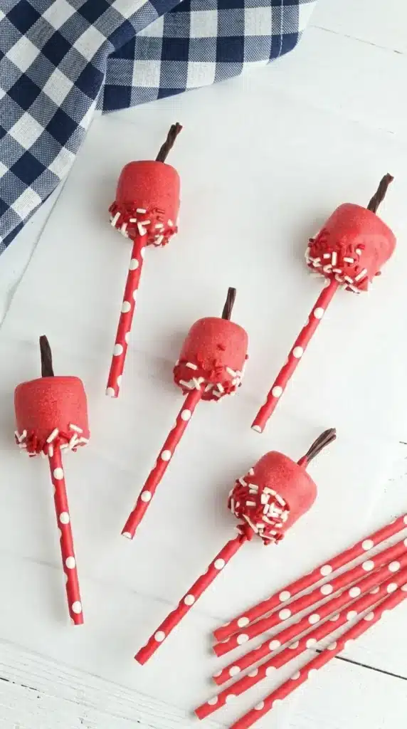 4th Of July Marshmallow Pops with patriotic sprinkles on blue paper straws