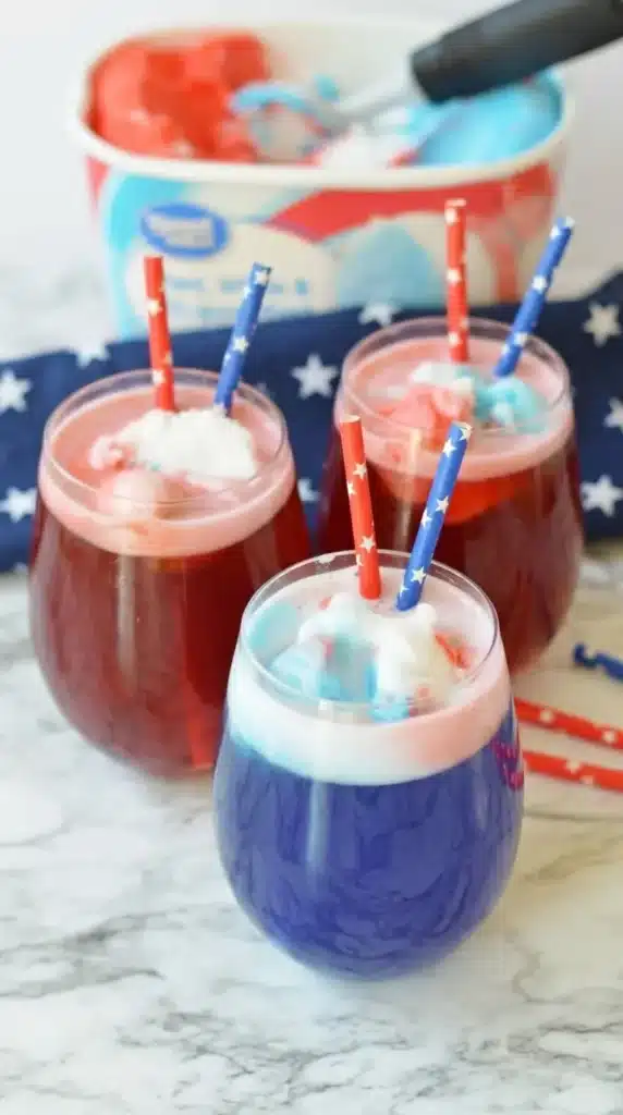 Easy 4th Of July punch with red white and blue sorbet in festive summer party glasses