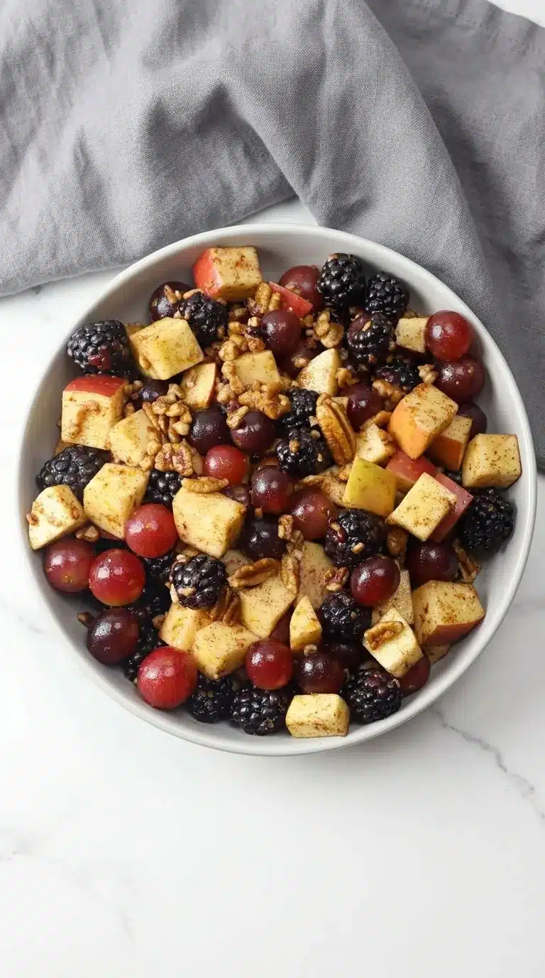 Fall fruit salad with apples, grapes, blackberries, pecans, and cinnamon dressing
