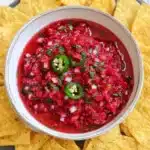 Fresh raspberry salsa with tortilla chips in a rustic bowl
