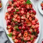 Watermelon Fruit Salad with strawberries cherries raspberries and fresh mint