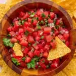 Fresh watermelon salsa with tortilla chips in a rustic bowl for a summer lunch appetizer