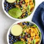 Grilled pineapple salad with avocado, blueberries, corn, and creamy citrus dressing