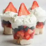 Mini shortcake cups with strawberries, blueberries, whipped cream, and angel food cake