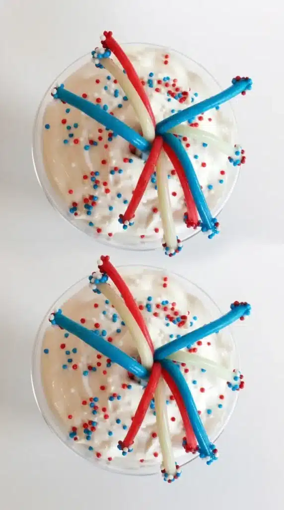 4th of July Dessert Fireworks Jello Cups topped with whipped cream and patriotic candy