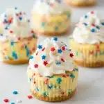 Patriotic Mini Cheesecakes with whipped cream and red white blue sprinkles