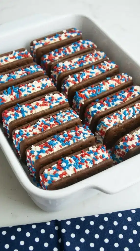 Patriotic Mini Ice Cream Sandwiches with red white and blue sprinkles on a white plate