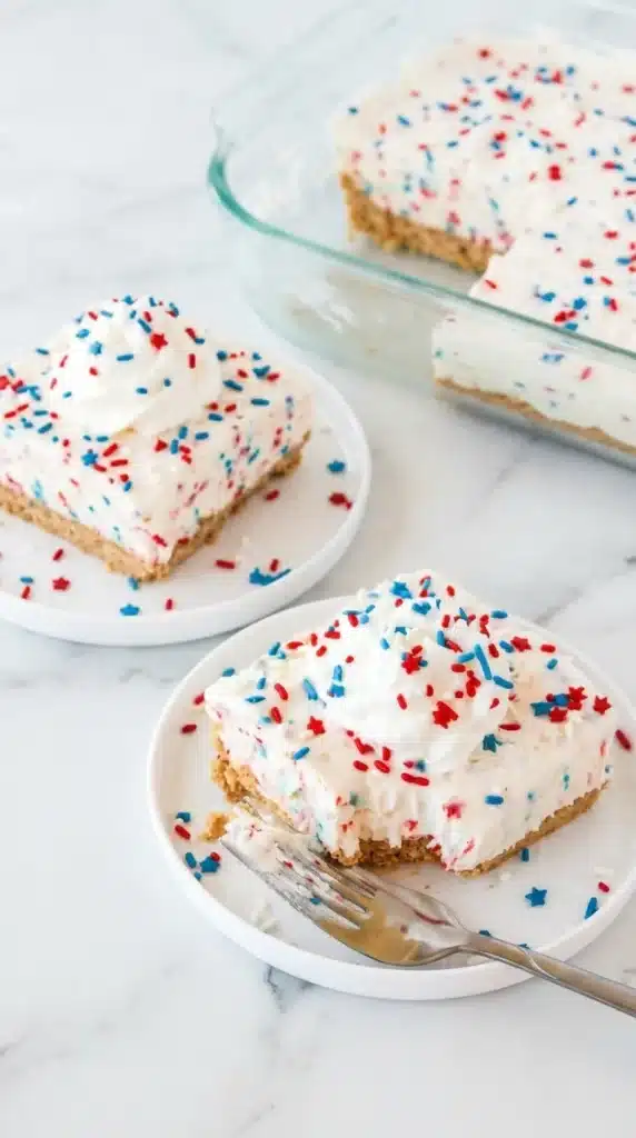 Patriotic No Bake Cheesecake bars with whipped cream and a bite taken out