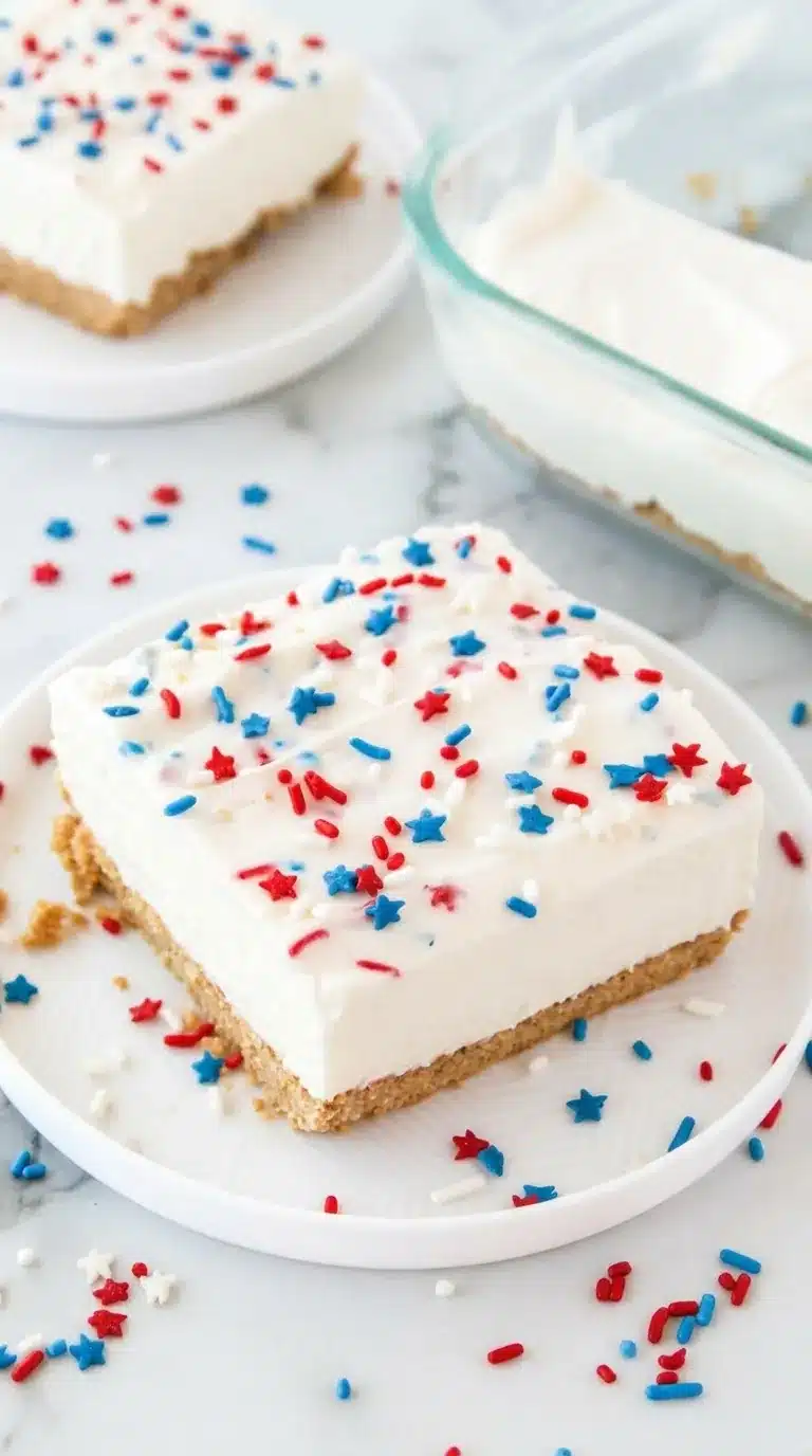 Patriotic no bake cheesecake with red white and blue sprinkles on a graham cracker crust