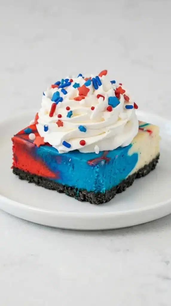 4th of July Red White and Blue Cheesecake Bars with whipped cream topping