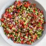 Fresh Persian Shirazi Salad with cucumber, tomato, and red onion in a rustic bowl