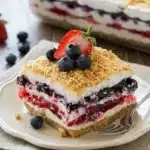 Red White & Blue Mixed Berry Yum Yum dessert slice with creamy layers and graham crust