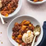 Sheet Pan Peach Crisp with vanilla ice cream and caramel drizzle