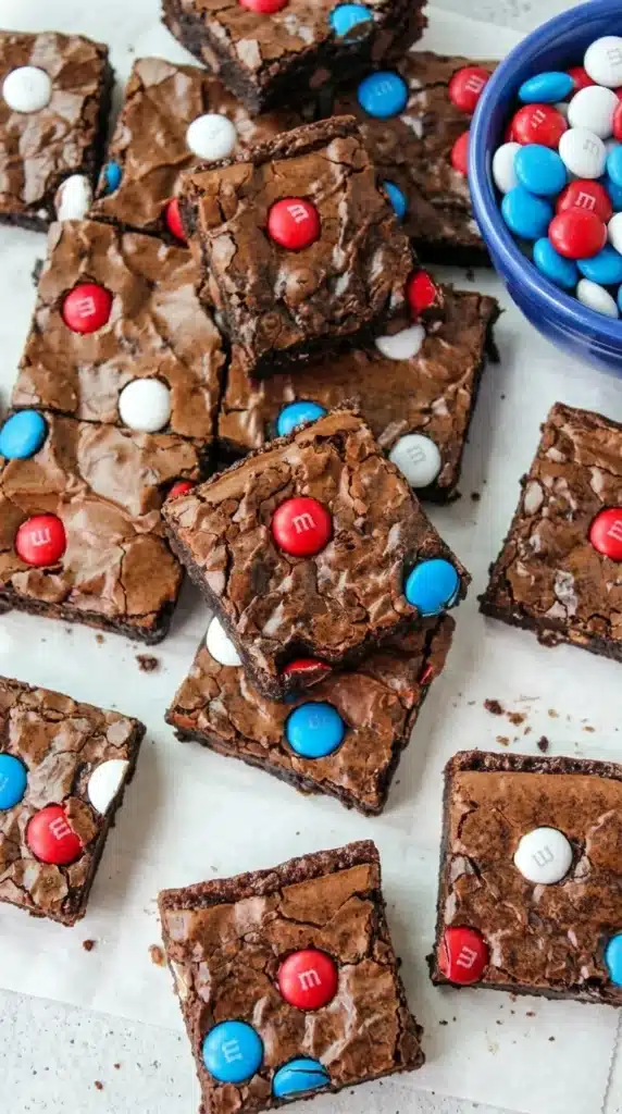 4th of July Brownies Easy Amazing Party Dessert 7 Stacked 4th of July Brownies with red white and blue candy topping