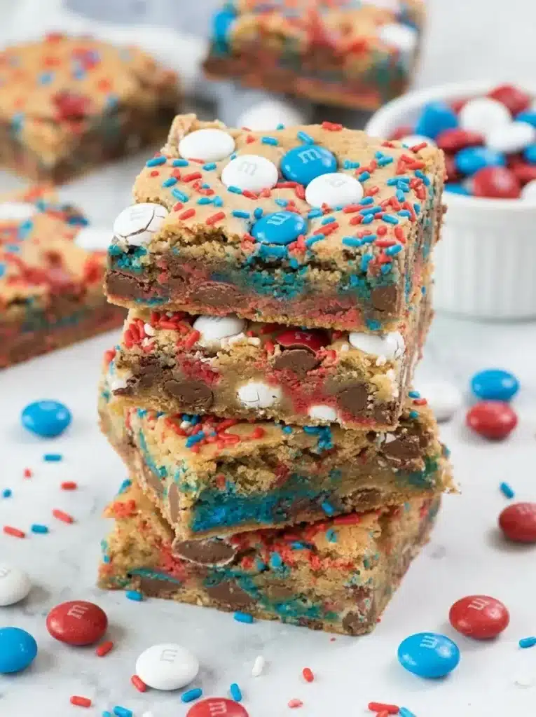 Stacked Fireworks Blondies with patriotic candies and colorful sprinkles
