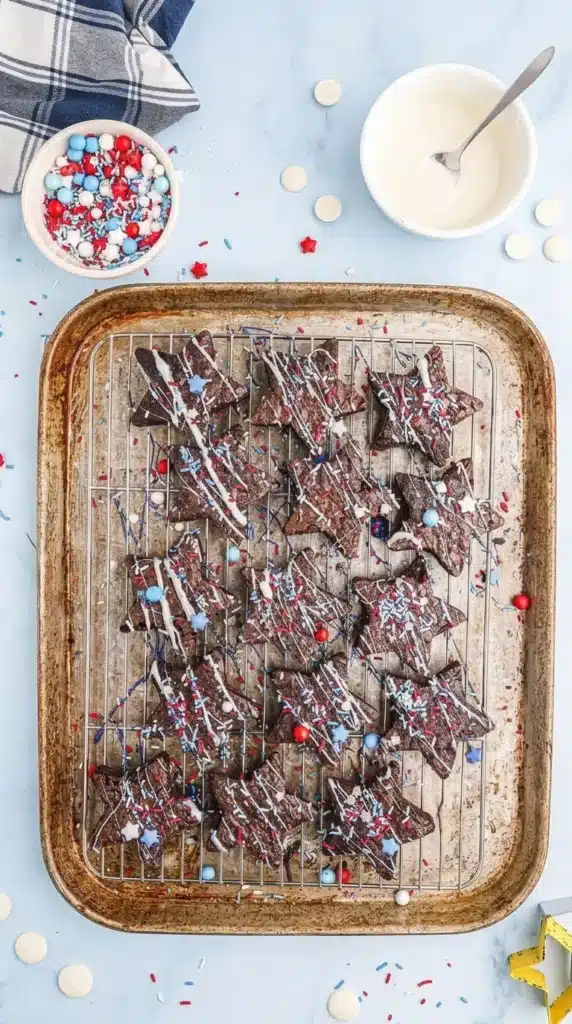  Star-Spangled Brownies decorated with sprinkles and icing on cooling rack