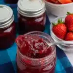 Homemade strawberry watermelon jam in a glass jar with fresh summer fruit