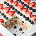 Summer Berry Icebox Cake slice with strawberries blueberries and creamy layers