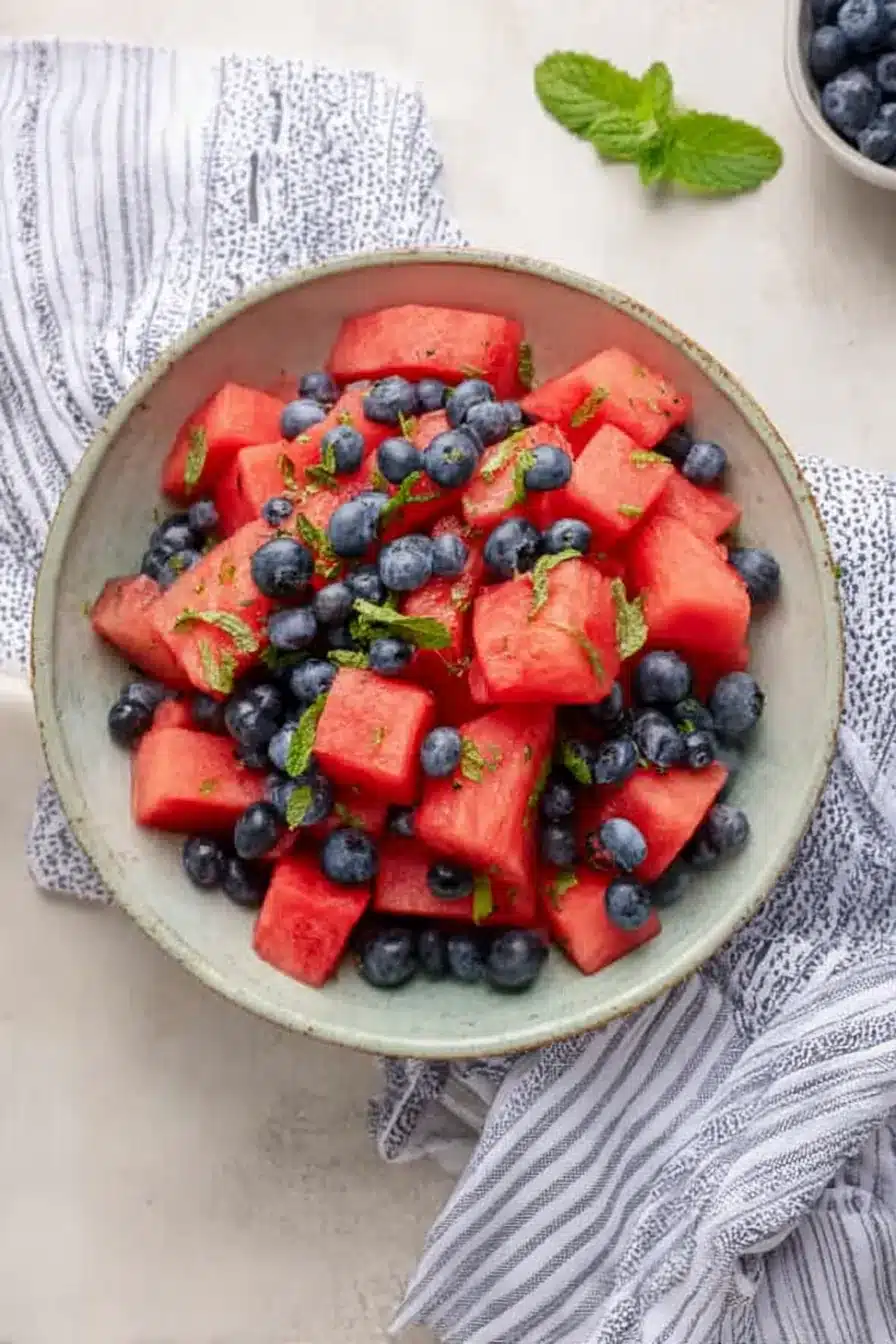 Fresh watermelon blueberry salad with mint in a ceramic bowl for a healthy summer fruit side dish