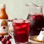 Cherry Pie Iced Tea served in a glass pitcher with cherry pie and fresh cherries