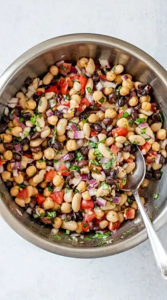 Lemon Basil Three Bean Salad Easy Amazing Lunch Recipe 7 Mixed Lemon Basil Three Bean Salad in a bowl with chickpeas, white beans, black beans, and basil