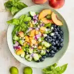 Blueberry Cucumber Salad with Peaches and Goat Cheese ingredients in a bowl