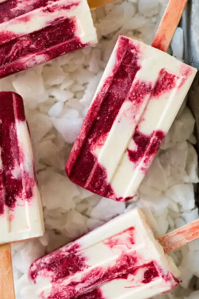 Cherry Creamsicles with vanilla cream swirls on crushed ice