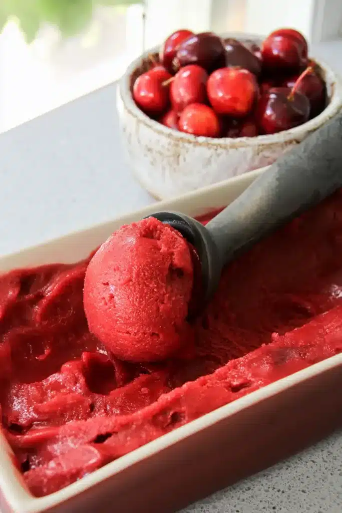 Cherry Sherbet Recipe Amazing Easy Summer Treat 4 Cherry Sherbet scooped from loaf pan with fresh cherries