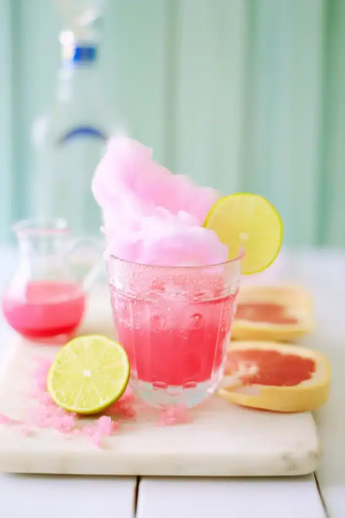 Cotton Candy Margarita with citrus slices and fluffy pink cotton candy garnish
