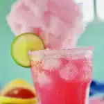 Cotton Candy Margarita with pink cotton candy garnish and fresh lime slices