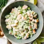 Cucumber shrimp salad with creamy lime dressing, fresh dill, cucumber, and green onions in a ceramic bowl