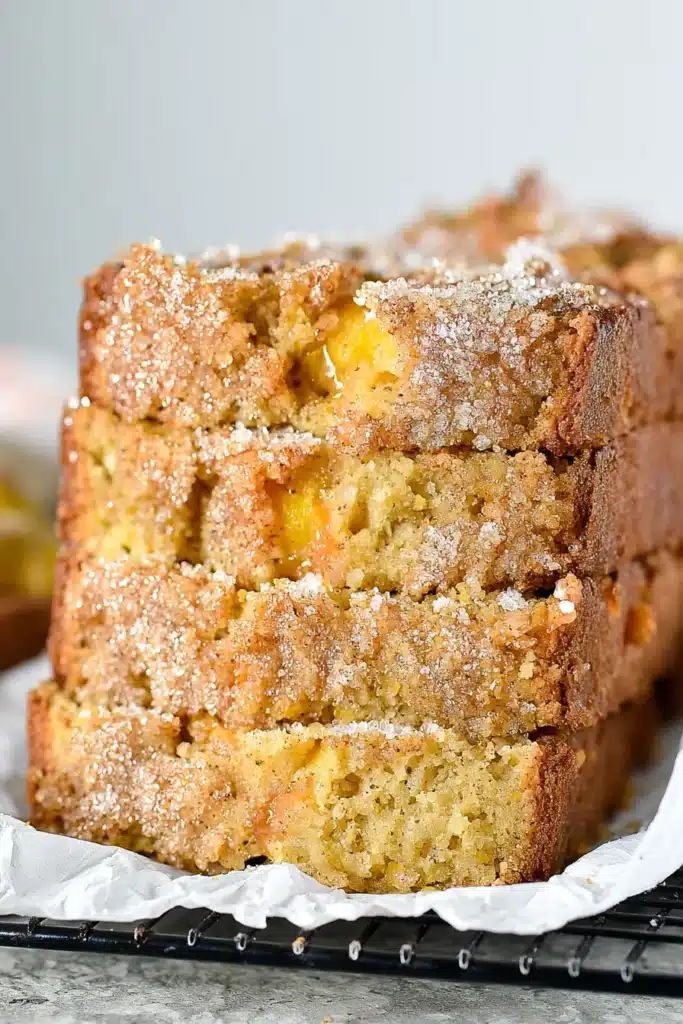 Easy Spiced Peach Bread Recipe | Amazing Cozy Flavor 7 Easy Spiced Peach Bread slice with juicy peach chunks and crumb topping