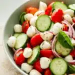 Fresh Cucumber Caprese Salad Easy Amazing Summer Recipe 7 Fresh Cucumber Caprese Salad with mozzarella, cherry tomatoes, cucumber, and basil in a serving bowl
