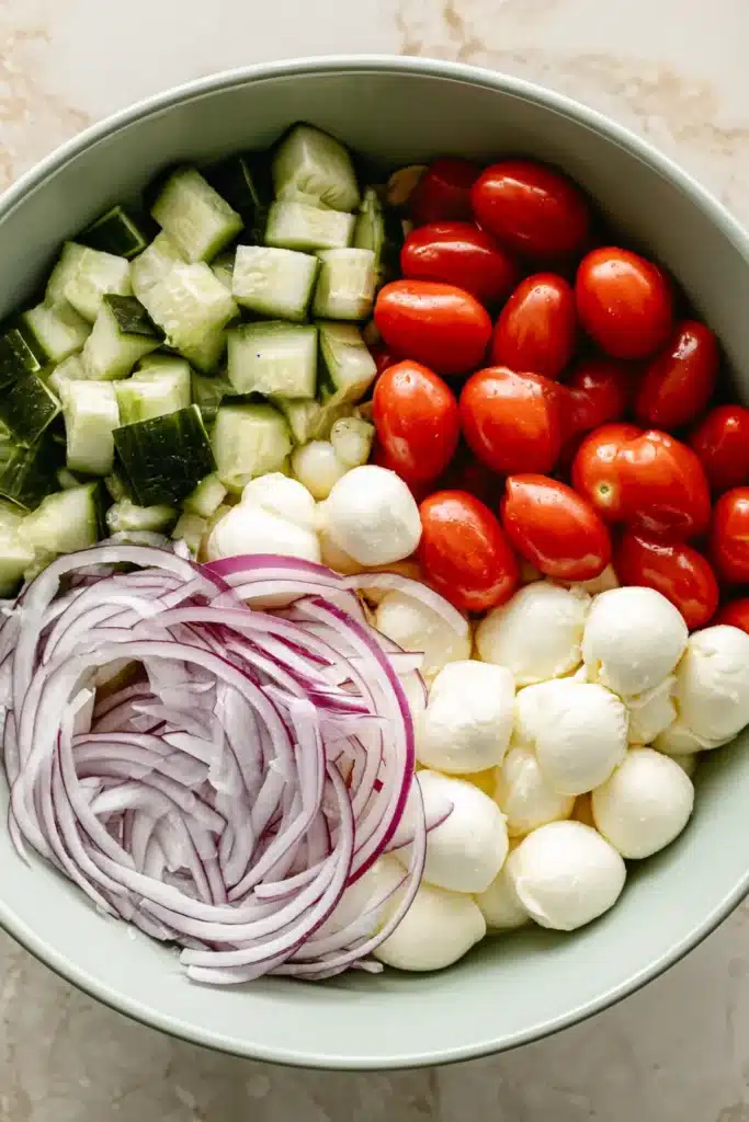 Fresh Cucumber Caprese Salad Easy Amazing Summer Recipe 5 Fresh Cucumber Caprese Salad ingredients with cucumber, mozzarella, tomatoes, and red onion