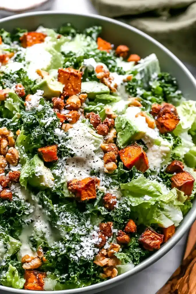 Healthy Kale Caesar Salad with roasted sweet potatoes, crispy chickpeas, and creamy Caesar dressing