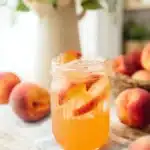 Homemade Peach Lemonade Easy Amazing Summer Favorite 7 Homemade Peach Lemonade with fresh peach slices and ice in a glass
