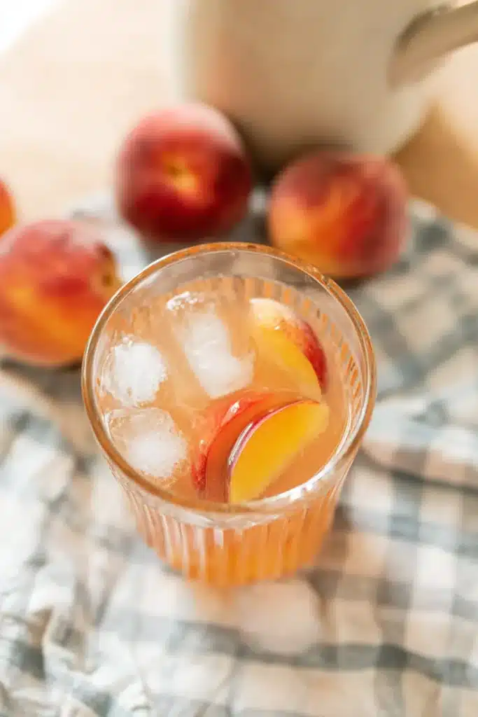 Homemade Peach Lemonade Easy Amazing Summer Favorite 5 Homemade Peach Lemonade with fresh peach slices and ice cubes in a glass jar