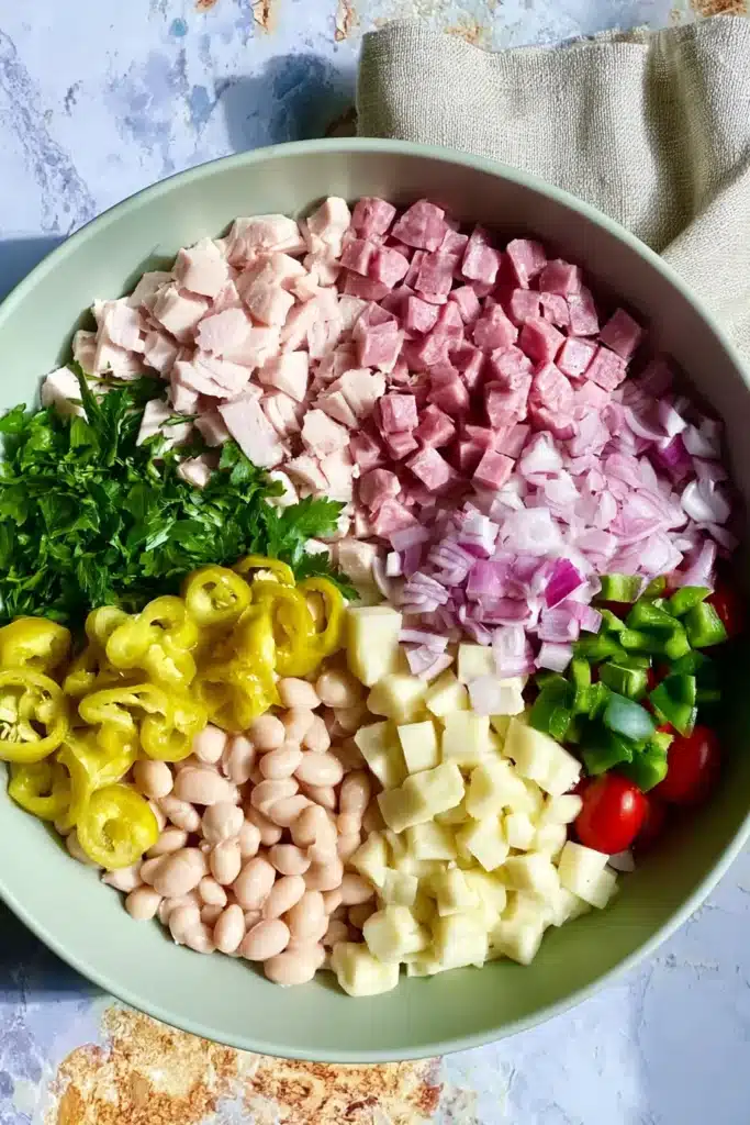 Italian Grinder Bean Salad ingredients arranged in a bowl before mixing