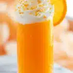 Orange Creamsicle Cocktail Recipe | Amazing Easy Summer Sip 7 Orange Creamsicle Cocktail topped with whipped cream and orange sprinkles