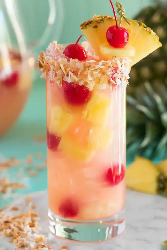 Pina Colada Sangria Recipe: Amazing Tropical Summer Favorite 6 Pina Colada Sangria with coconut rim, pineapple garnish, and cherries