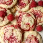 Soft chewy lemon raspberry cookies topped with flaky sea salt and fresh raspberries