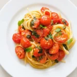 Tomato Basil Pasta Recipe | Amazing Easy Italian Dinner 9 Tomato basil pasta with cherry tomatoes, fresh basil, and spaghetti in a bowl