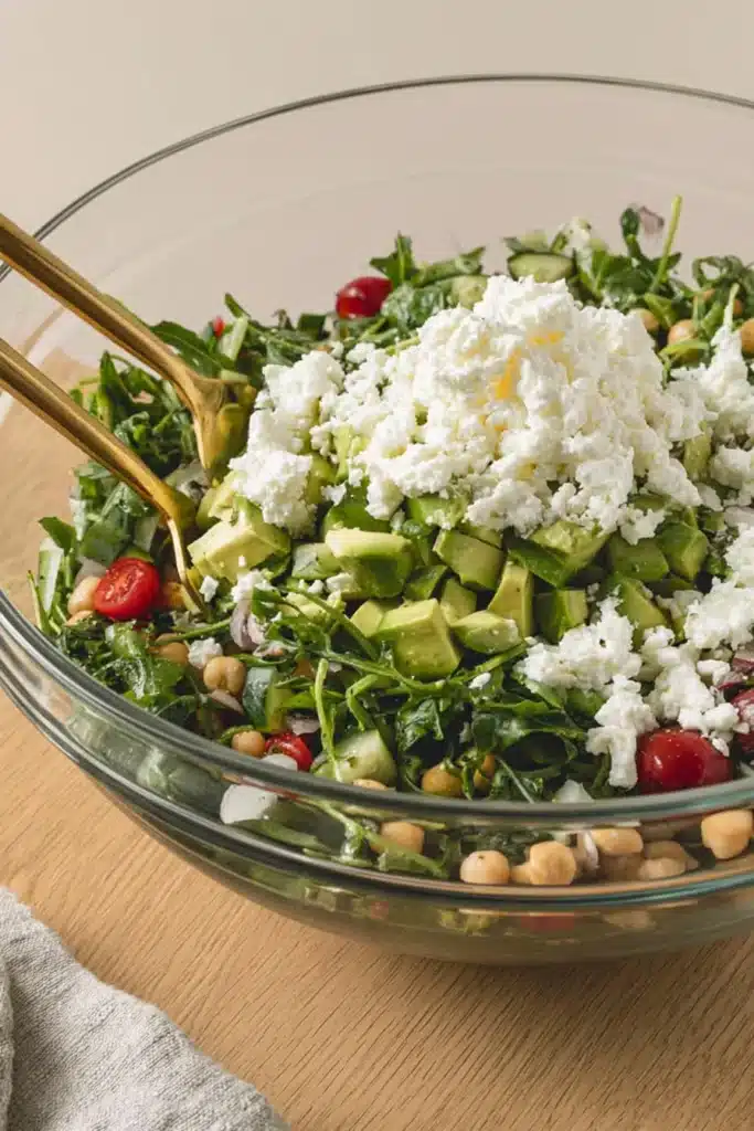 Chickpea Avocado Salad tossed with fresh vegetables and lemon herb dressing