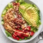 Chicken Avocado Salad with grilled chicken, avocado, bacon, tomatoes, and Honey Dijon dressing
