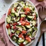 Easy Greek Cucumber Salad | Amazing Fresh Summer Recipe 11 Easy Greek Cucumber Salad with feta, tomatoes, cucumbers, olives, and red onion in a serving platter