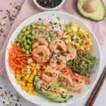 Easy Shrimp Poke Bowl with cooked shrimp, avocado, rice, vegetables, and spicy mayo in a ceramic bowl