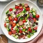 Fresh Greek Salad with cucumber, tomatoes, feta cheese, Kalamata olives, and homemade Greek dressing.