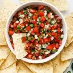 Pico de Gallo Recipe | Amazing Fresh Mexican Salsa 9 Fresh homemade Pico de Gallo served with crispy tortilla chips in a ceramic bowl