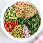 Mediterranean Quinoa Salad ingredients in a bowl with fresh vegetables