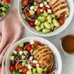 Greek Chicken Salad with grilled chicken, avocado, feta, cucumber, tomatoes, and olives
